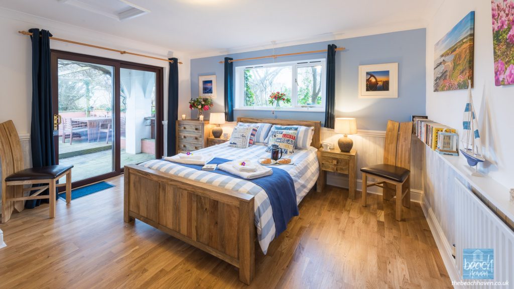 The spacious master bedroom with with king-size bed and en-suite at The Beach Haven holiday accommodation in Cornwall